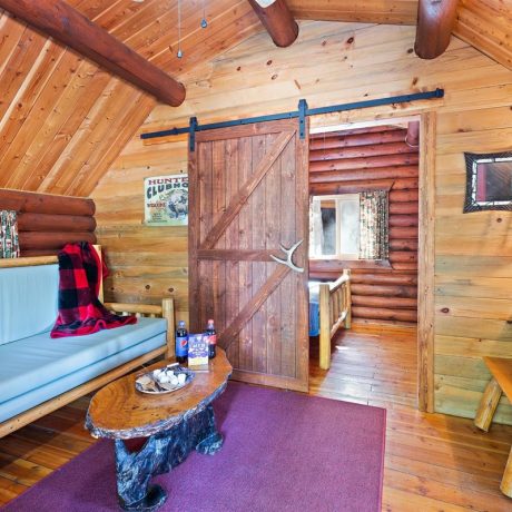 Image of cabin living room interior with long couch at Nugget RV Park