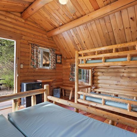 Image of cabin interior with bunk beds and full bed at Nugget RV Park
